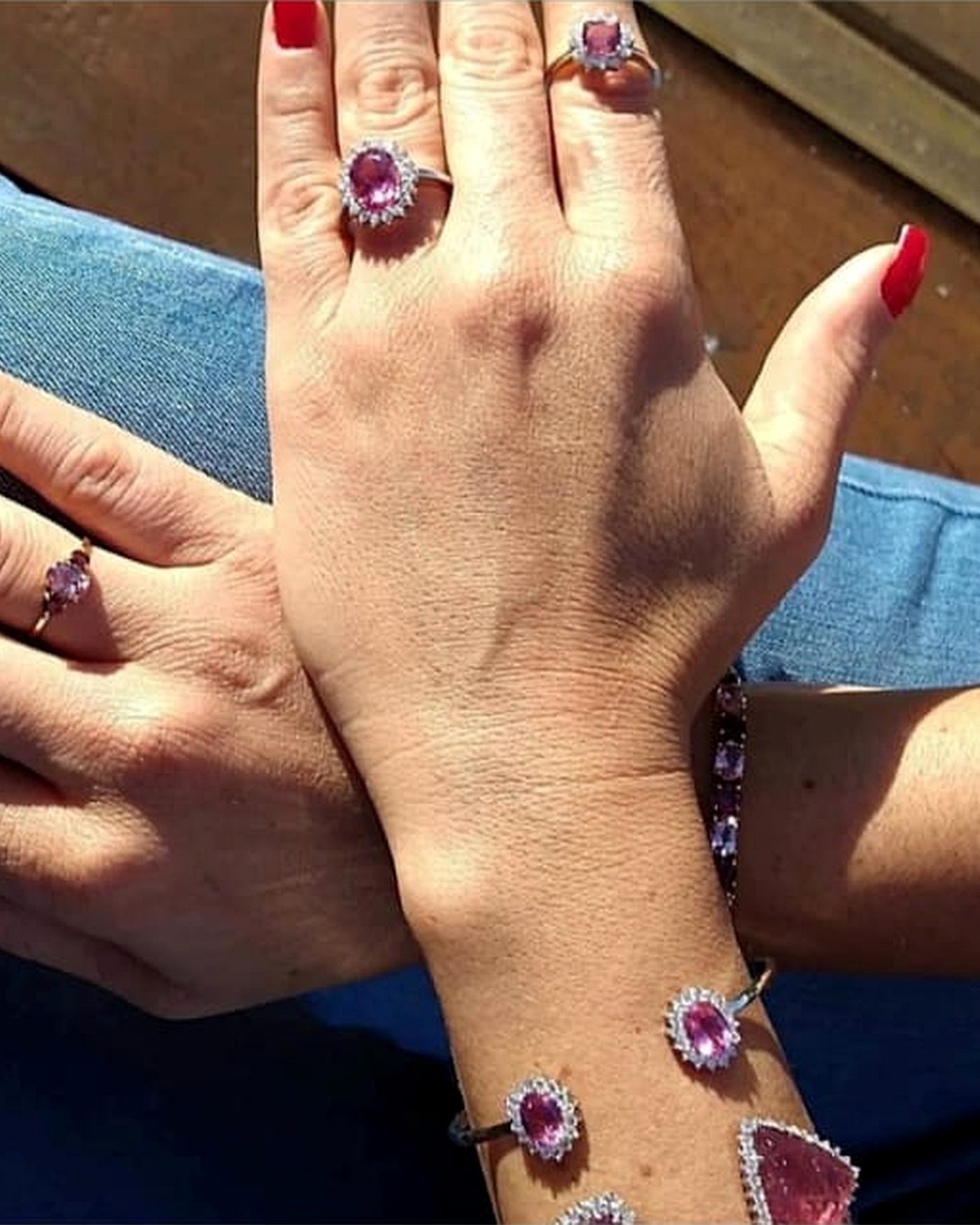 A suite of rose tourmaline rings and bracelet worn together