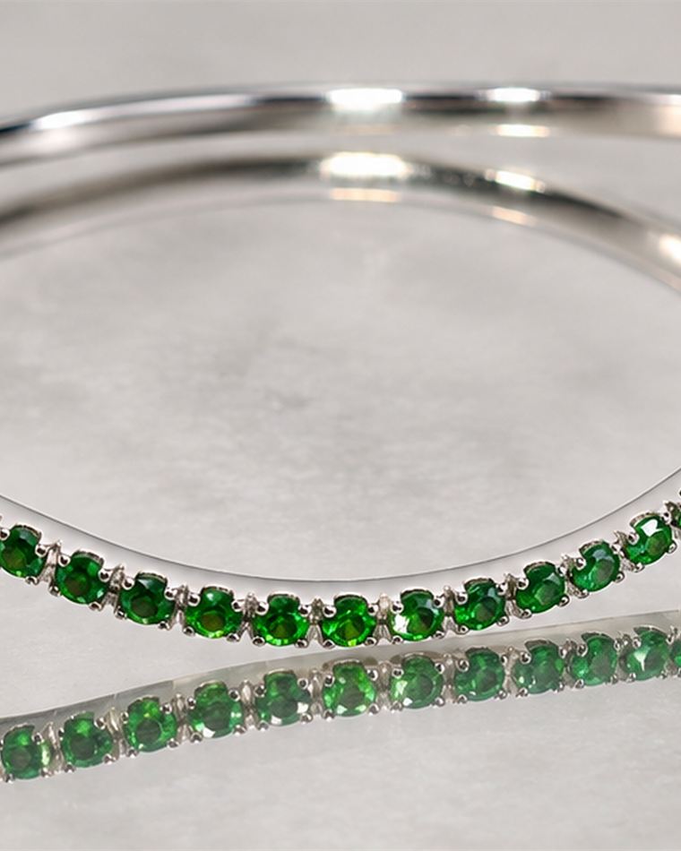 Pair of crossing line bangles, one white and one green